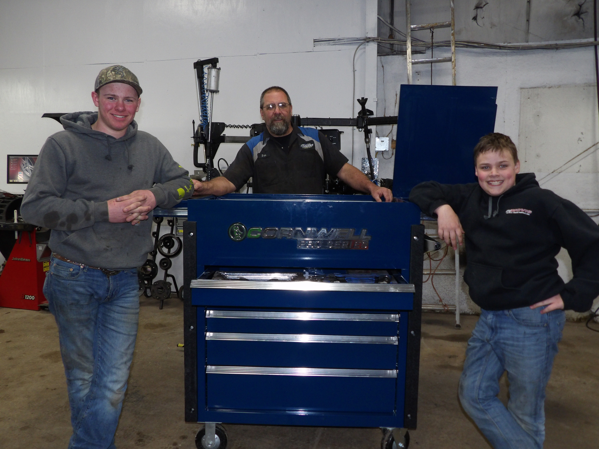 Eric Henricks (center) and the next generation of Henricks' Auto Service, Cameron (left) and Connor (right).