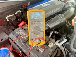 Digital multimeter testing a battery Digital multimeter testing a battery