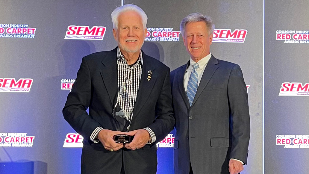 Bill Eveland, on behalf of Eveland Brothers Collision Repair, Inc., accepts the Russ Verona Memorial Award from John Van Alstyne, I-CAR CEO and president.