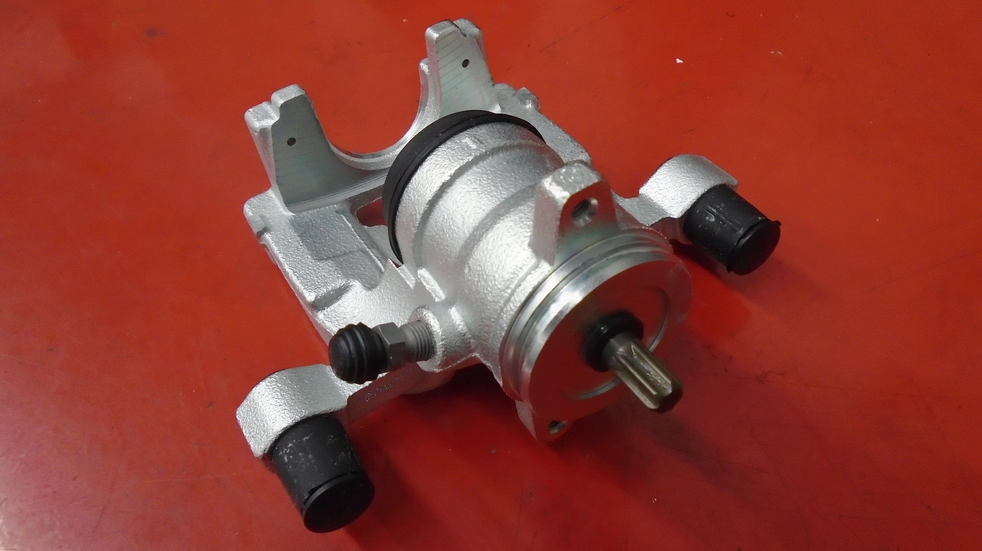 Figure 3: Brand new caliper with the actuator motor removed. The splined shaft visibly meshes with the actuator when installed.
