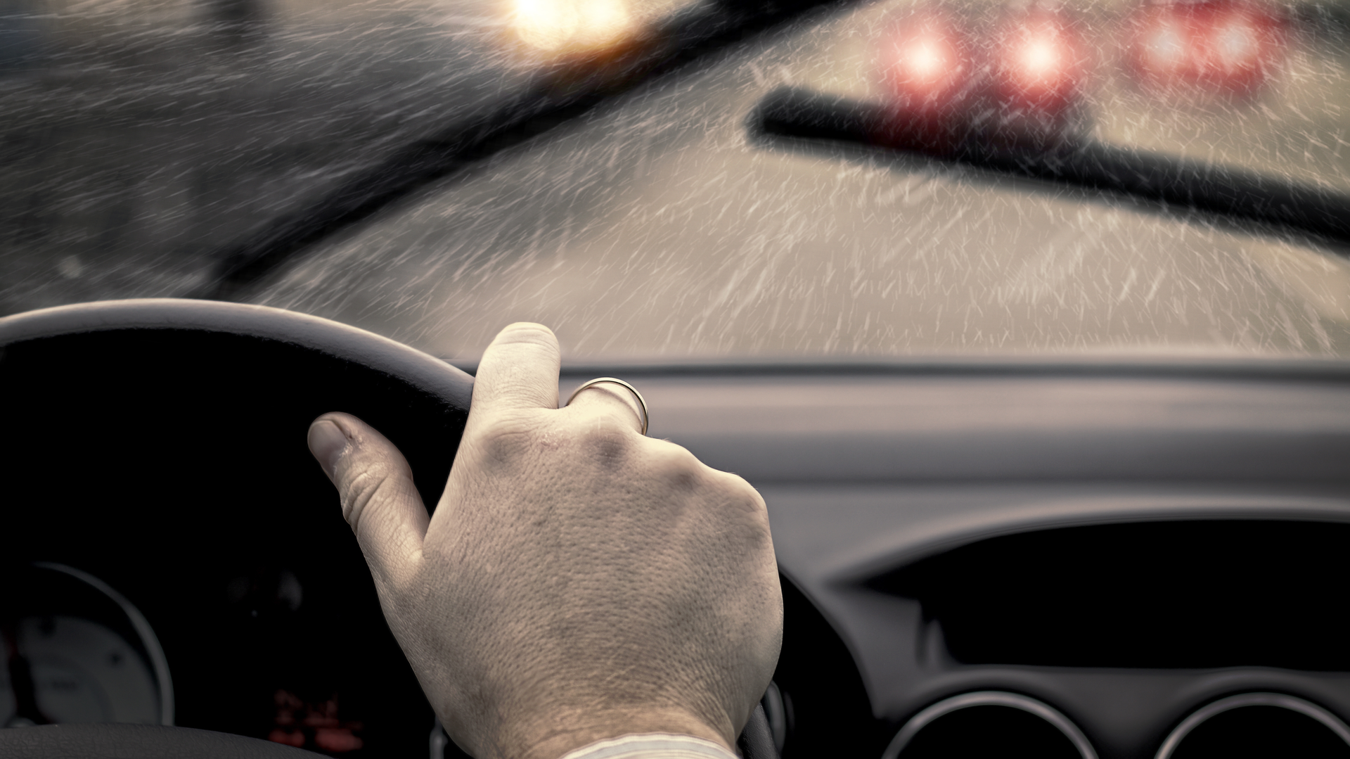 Car stopping in the rain