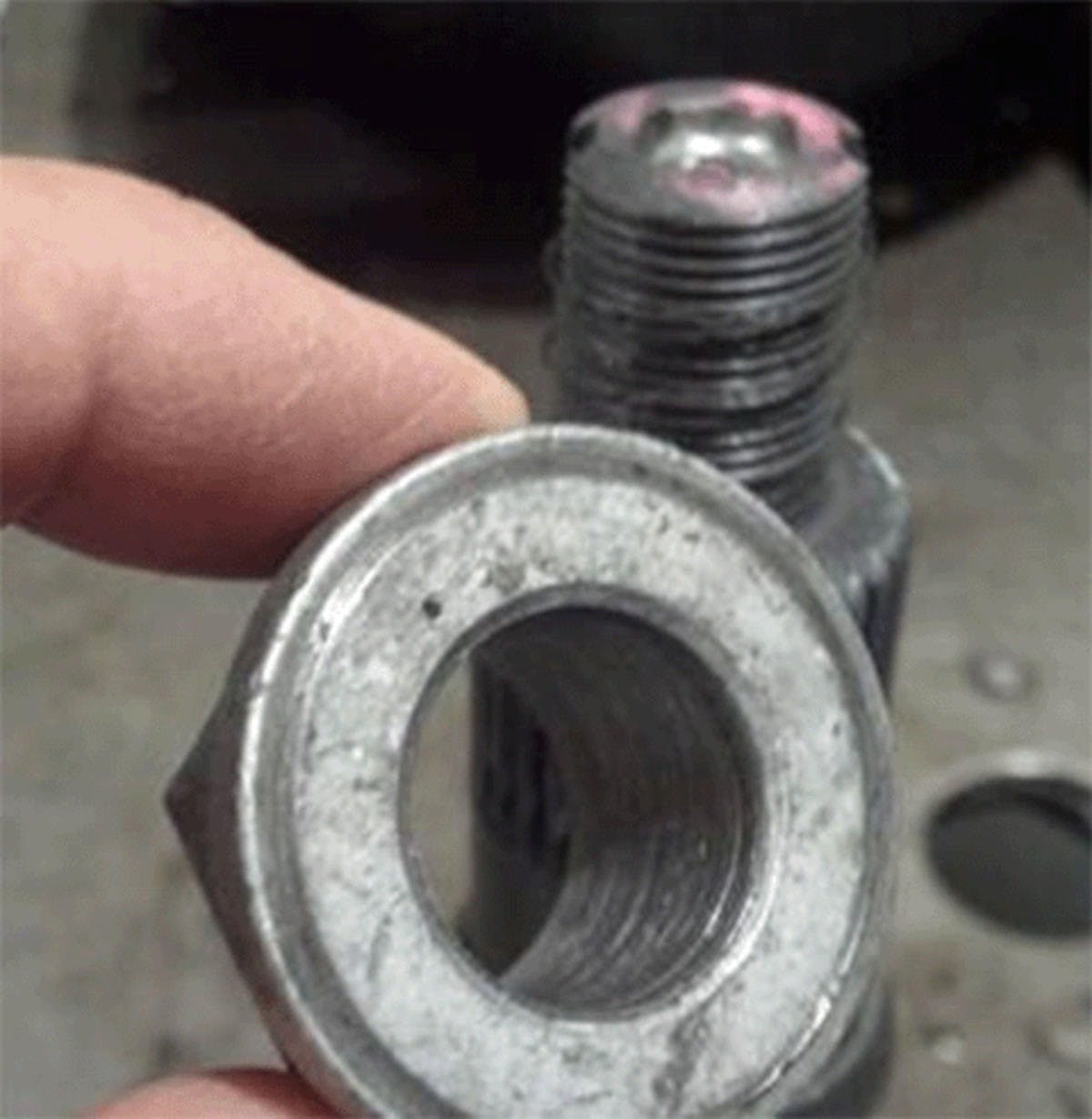 The pinion nut mating surface may have mating surface imperfections, resulting in nut thread deformation.