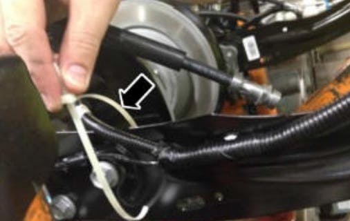Route the rear brake skid control wiring harness away from both rear wheels.