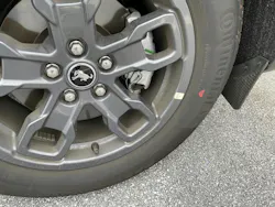 Example of a tire mounted. This tire features only a red dot, with no yellow dot. The wheel features a sticker indicating the wheel low point. The tire is mounted to align the red dot (highest point of radial runout) to this sticker. Example of a tire mounted. This tire features only a red dot, with no yellow dot. The wheel features a sticker indicating the wheel low point. The tire is mounted to align the red dot (highest point of radial runout) to this sticker.