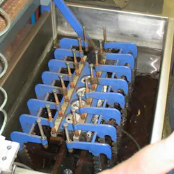 Pressure testing a cylinder head. All water ports are plugged except for one, where compressed air is introduced. Any cracks or porosity issues will be evident by air bubbles escaping. Pressure testing a cylinder head. All water ports are plugged except for one, where compressed air is introduced. Any cracks or porosity issues will be evident by air bubbles escaping.