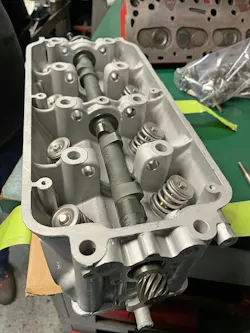 Checking cam bores for play/bind in an OHV cylinder head using a known-good/straight camshaft. Checking cam bores for play/bind in an OHV cylinder head using a known-good/straight camshaft.