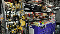 The interior of a tool truck with a large toolbox and the walls and ceiling stocked with automotive tools The interior of a tool truck with a large toolbox and the walls and ceiling stocked with automotive tools