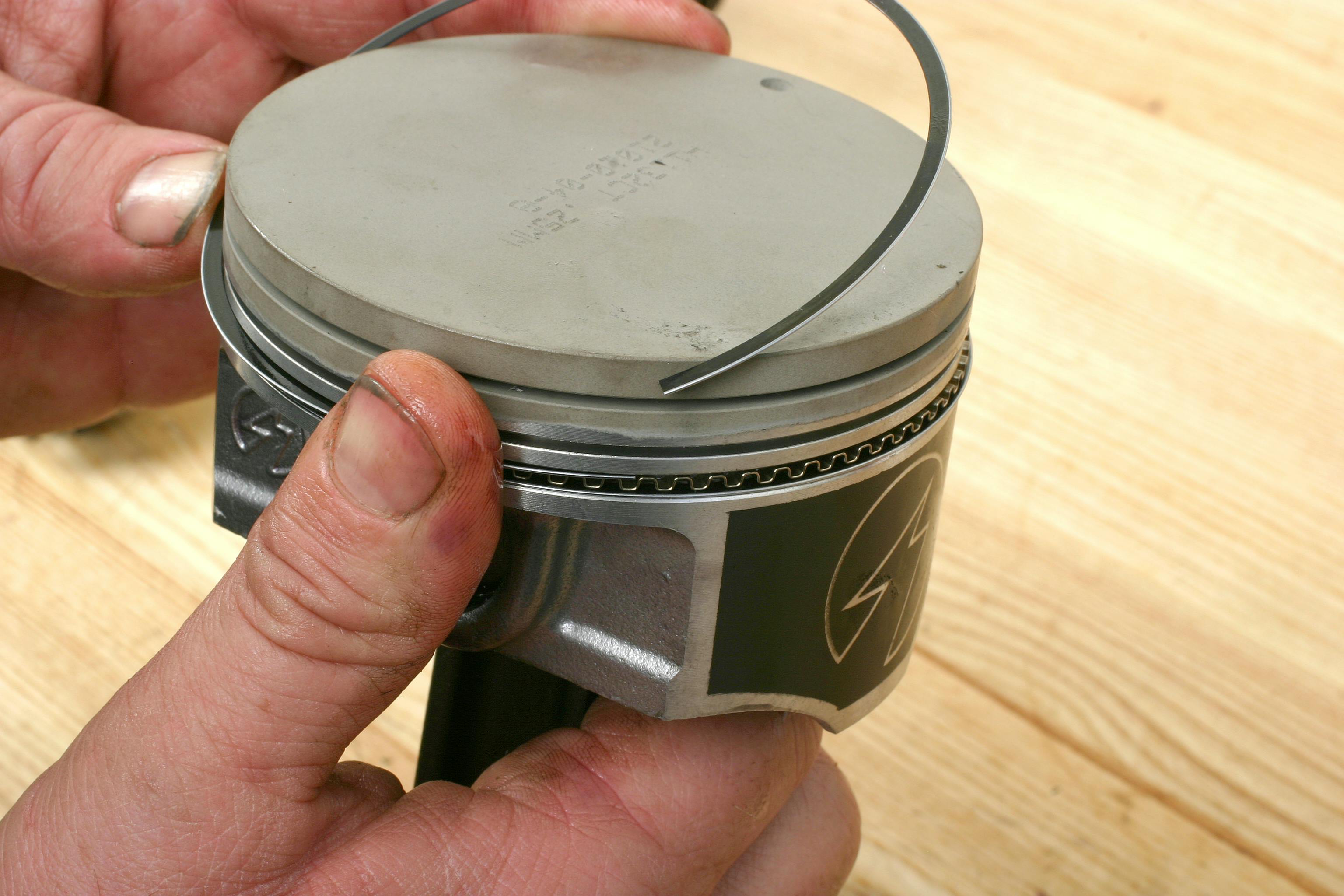 With the expander installed, next install the lower oil scraper ring. This will secure the expander ring, keeping the expander ends butted together. Next install the upper scraper ring. This completes the oil ring package. Be sure to orient the clock positions of the upper and lower scrapers to keep their end gaps far away from each other (90 degrees apart, 180 degrees apart, or whatever orientation specs recommend.