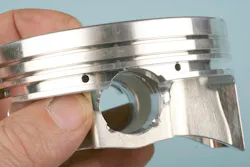 Some pistons may feature a short CD (compression distance), resulting in the wrist pin bore intersecting the oil ring groove. Some pistons may feature a short CD (compression distance), resulting in the wrist pin bore intersecting the oil ring groove.