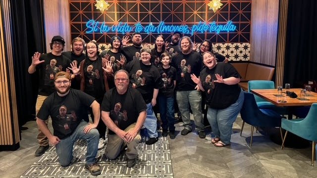 The team and their spouses all rocking t-shirts with Chuck's face printed on them.