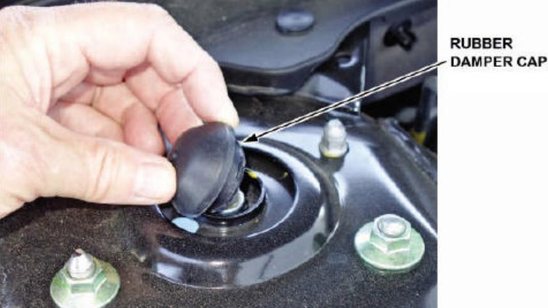 If the rattle noise goes away with caps removed, replace the rubber damper caps with the new part number.