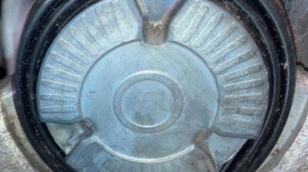 Clean the area and check whether there is moisture underneath the protective sleeve. If there is no moisture in this area, re-assess the complaint and continue evaluating the rest of the brake system. The photo here shows a dry state.