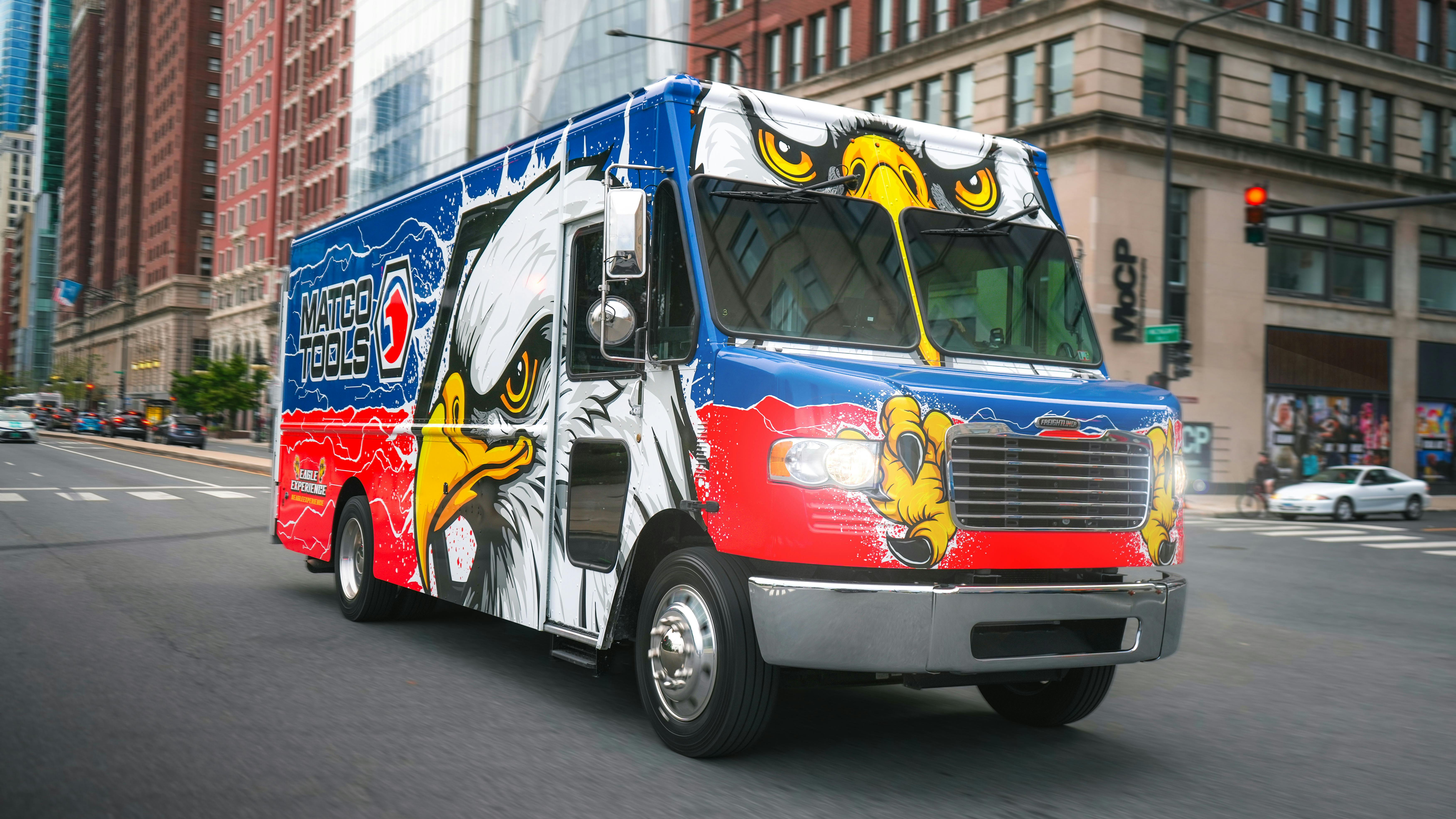 a Matco Tools branded tool truck on a rural road