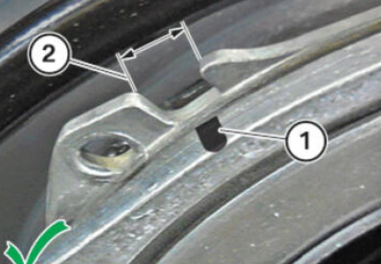 The black mark on the tensioner needs to be centered in the adjustment window.
