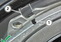 The black mark on the tensioner needs to be centered in the adjustment window. The black mark on the tensioner needs to be centered in the adjustment window.