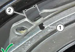 The black mark on the tensioner needs to be centered in the adjustment window. The black mark on the tensioner needs to be centered in the adjustment window.