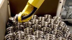 Once the finished bearing races have been automatically measured the hardturned components are engraved and then placed in shipping containers by the robot Once the finished bearing races have been automatically measured the hardturned components are engraved and then placed in shipping containers by the robot