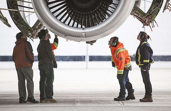 Employees at Pratt amp Whitneyrsquos Mirabel Flight Test Center in Quebec inspect the PurePower Geared Turbofan PW1900G engine as it runs in preparation for its inaugural flight
