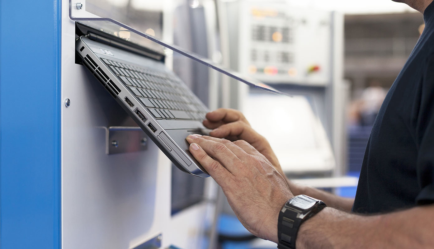 Programmer/machine tool operator at a control panel.