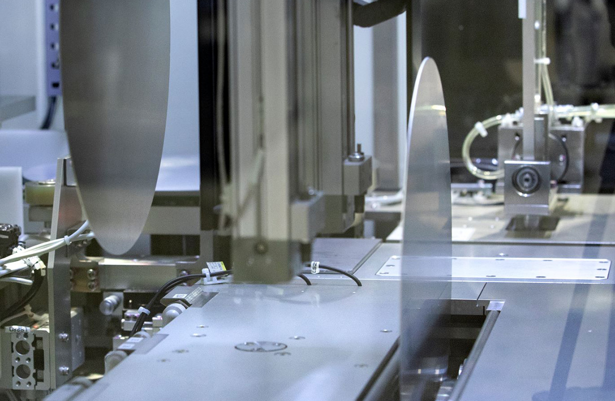 The interior of the DXSG320 wafer grinder showing two wafers in position for grinding.