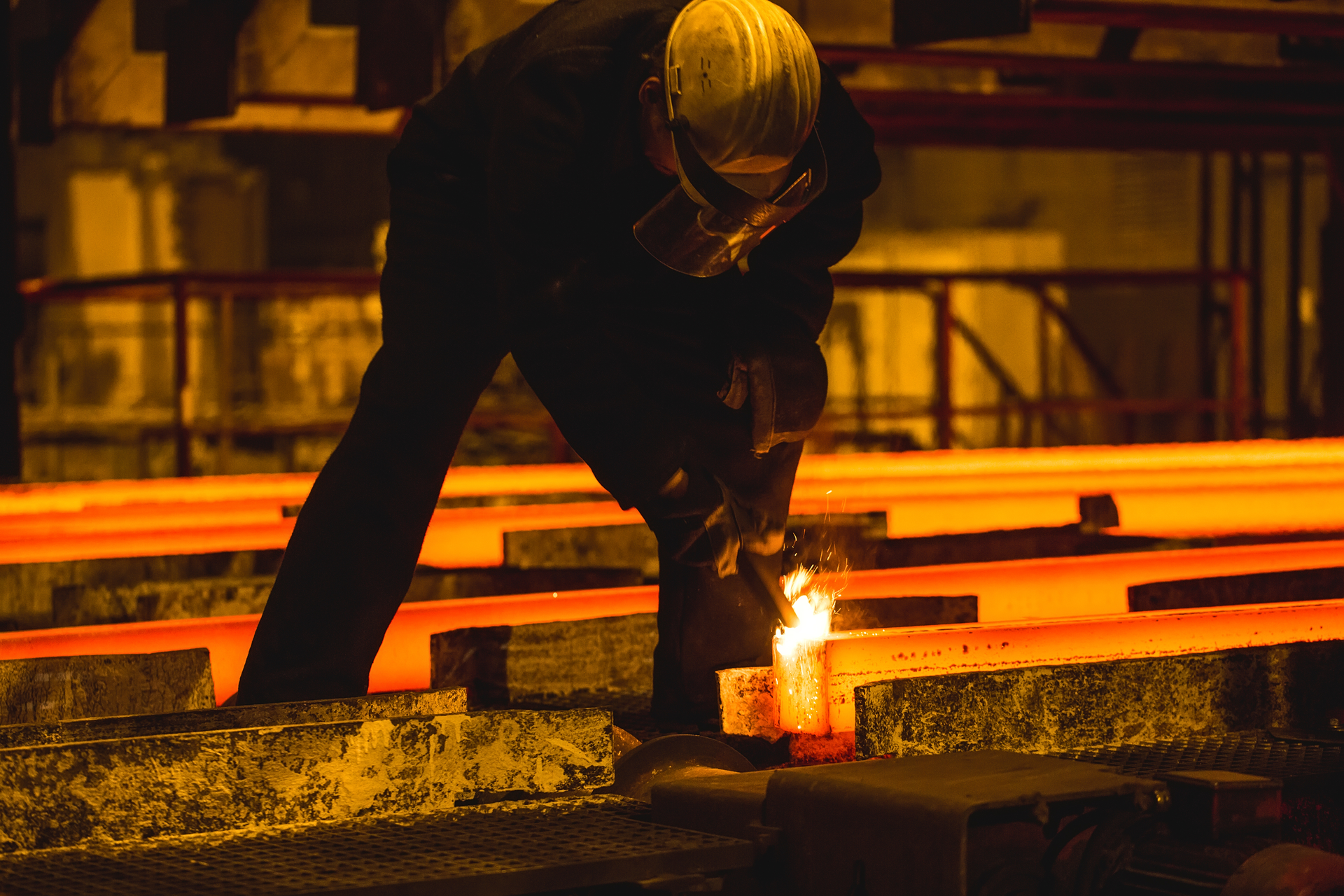 Steel billets, torch cutting at the run-out stage of continuous casting.