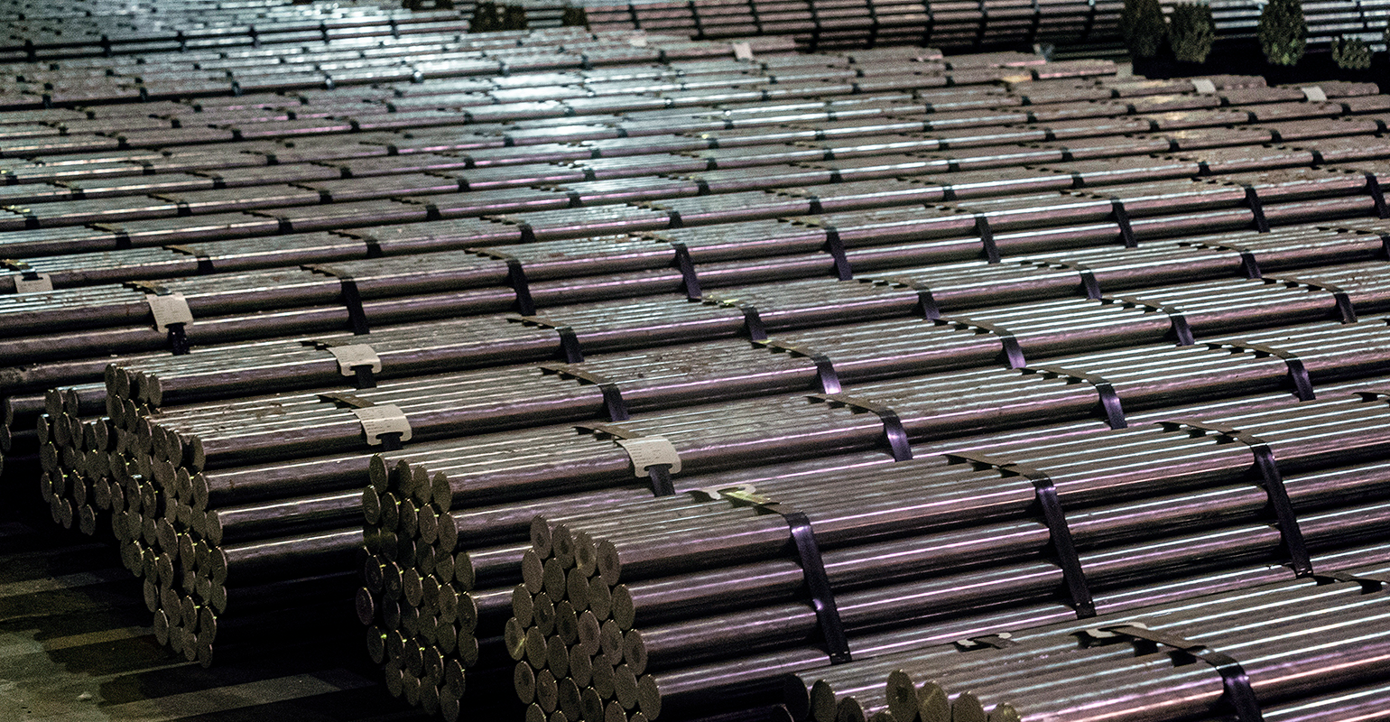 Steel bars stored in a warehouse.