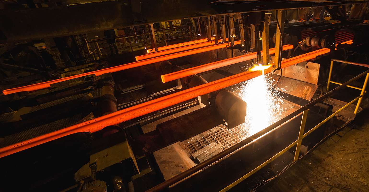 Continuous-cast steel billets at torch cutting.