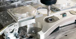 CNC milling machine with an automotive part. CNC milling machine with an automotive part.