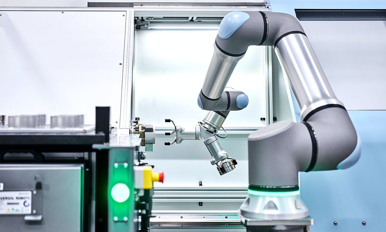 A CNC machine-tending Universal Robots UR30 cobot.