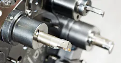 Cutting tools on an automated lathe. Cutting tools on an automated lathe.