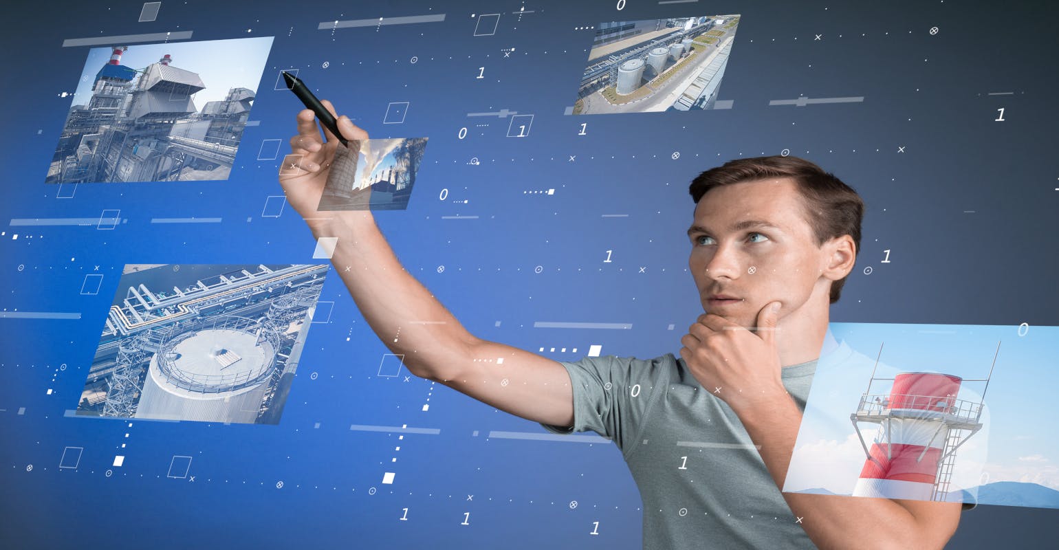 Young engineer/technologist working with virtual interface&hellip; Industrial enterprise management.