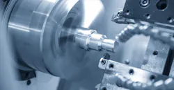 A CNC lathe machine cutting the thread at the metal parts. A CNC lathe machine cutting the thread at the metal parts.