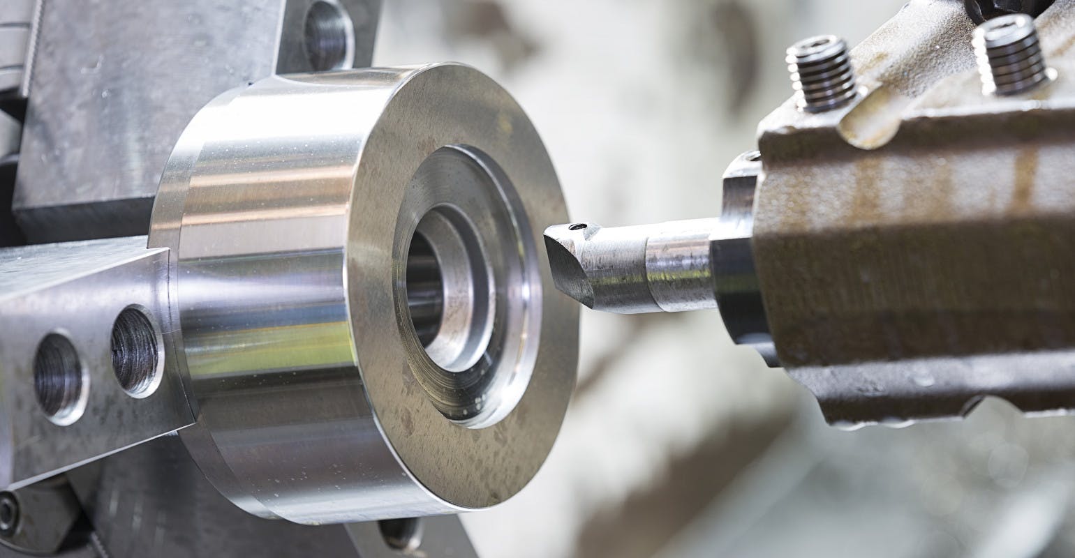 Machining a mold and die part by CNC turning.