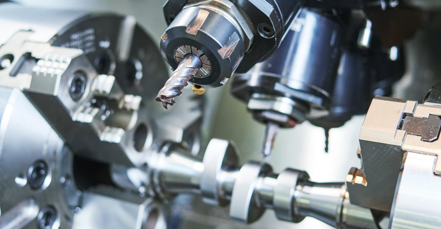 CNC turning of an automotive CAM shaft.