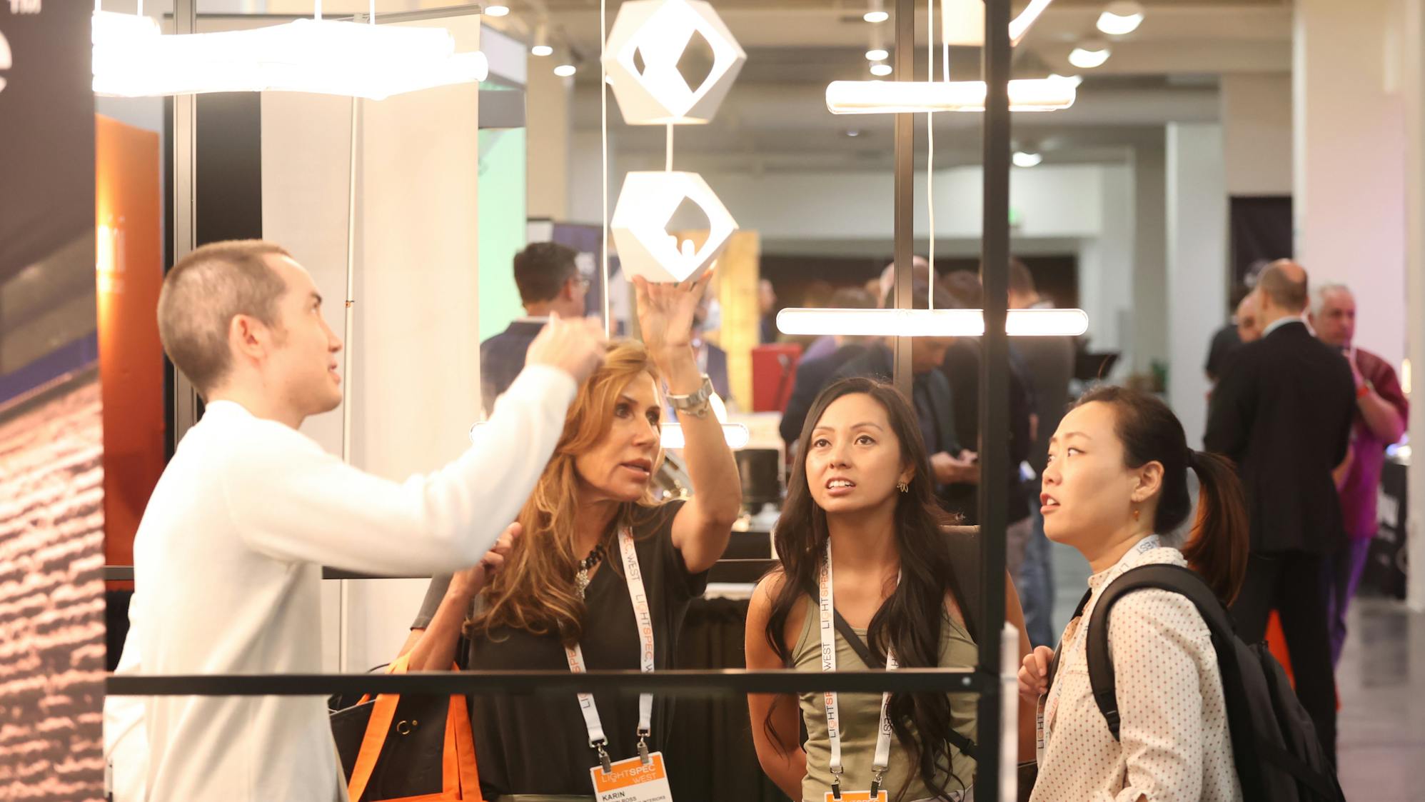 People looking at lighting fixture at LightSPEC West.