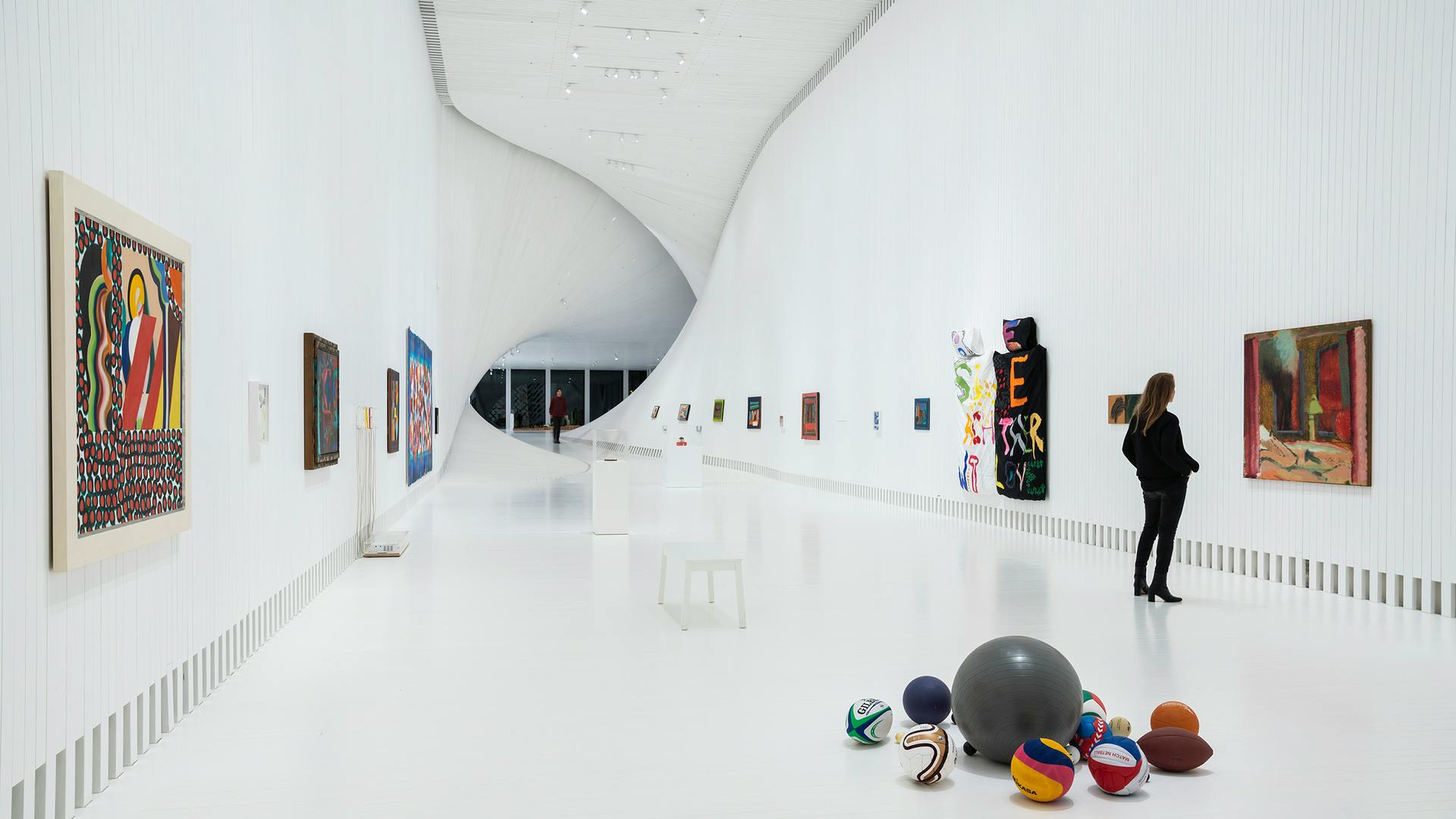 Designed by Bjarke Ingels Group with lighting design by Light Bureau, The Twist gallery in the Norwegian museum and sculpture park Kistefos uses wall washers to provide even lighting effects in the nearly 30 feet tall exhibition rooms and emphasize the curved architecture.