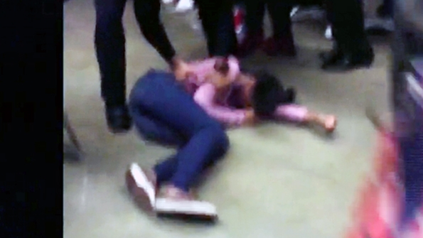 A girl at Rolesville High School in Rolesville NC lies on the ground after being bodyslammed by a school resource officer