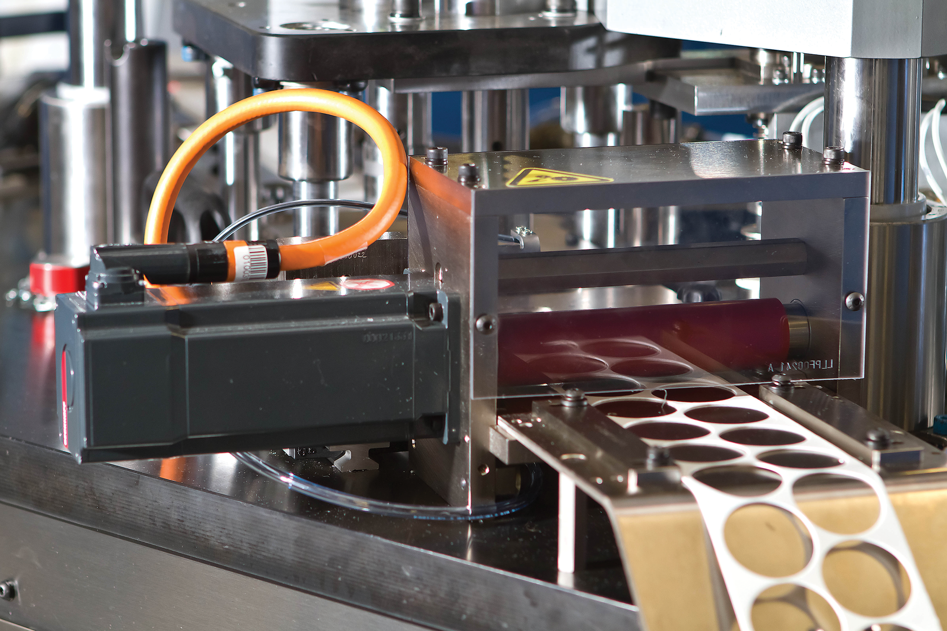 Cap liner. Among the machines built by MMC are those that cut and insert lining material into newly molded caps and closures.