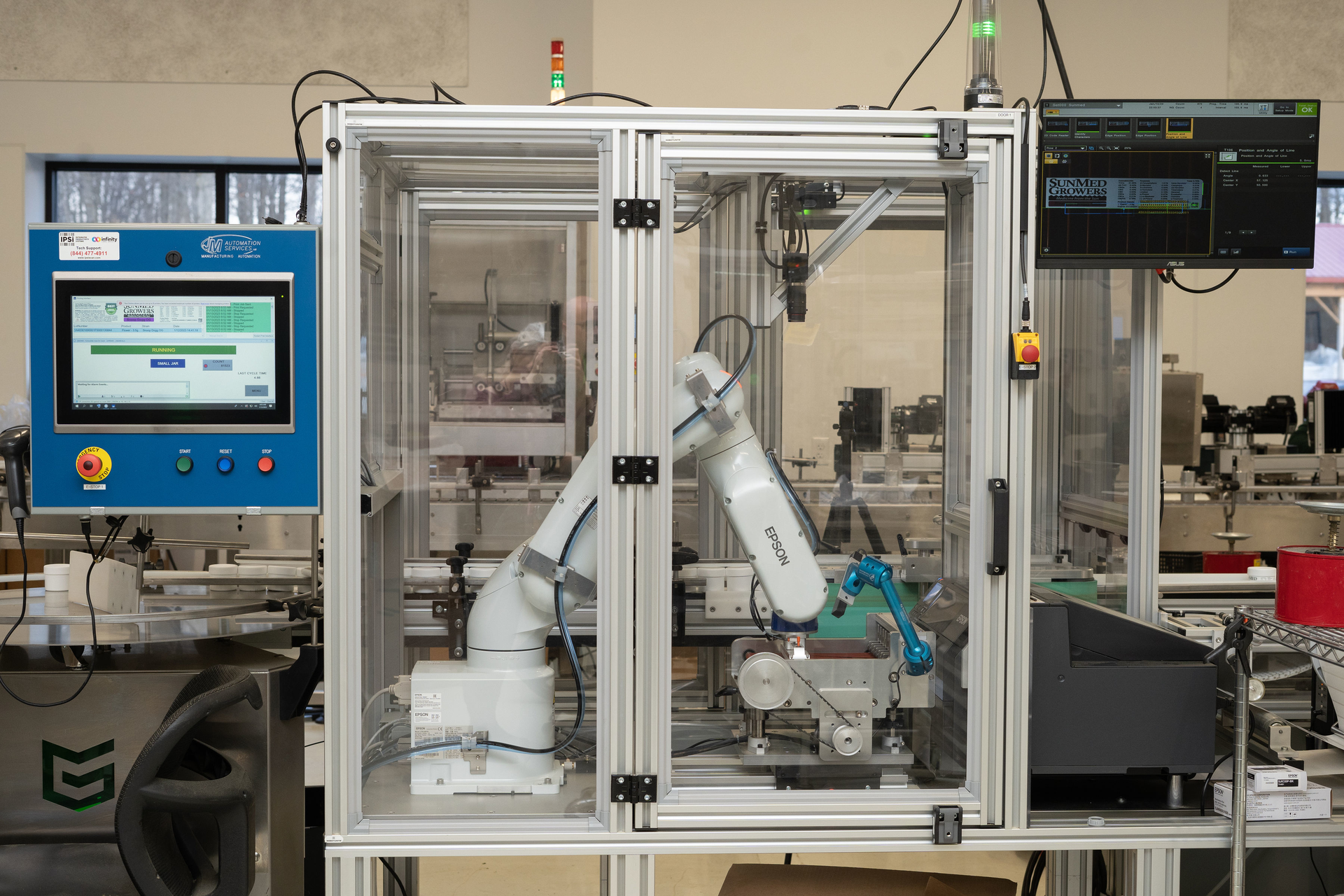 The robotic print-and-apply system at SunMed Growers features an Epson ColorWorks industrial, on-demand color label printer and Epson&rsquo;s VT6L six-axis robot.