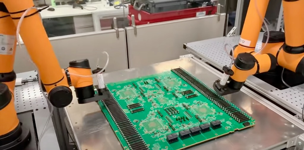 Rapid Robotics' robots featuring custom grippers for printed circuit board assembly.
