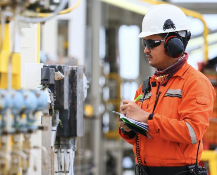 engineer checking devices at a process plant