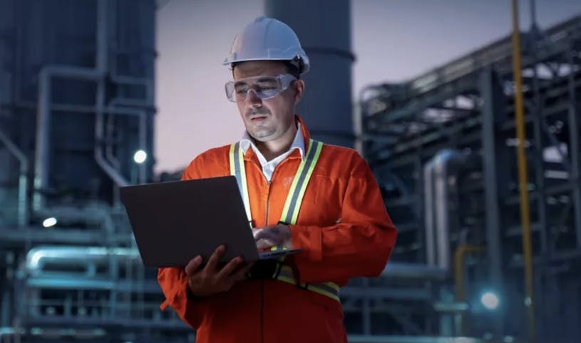 engineer reviews operational data at a processing facility