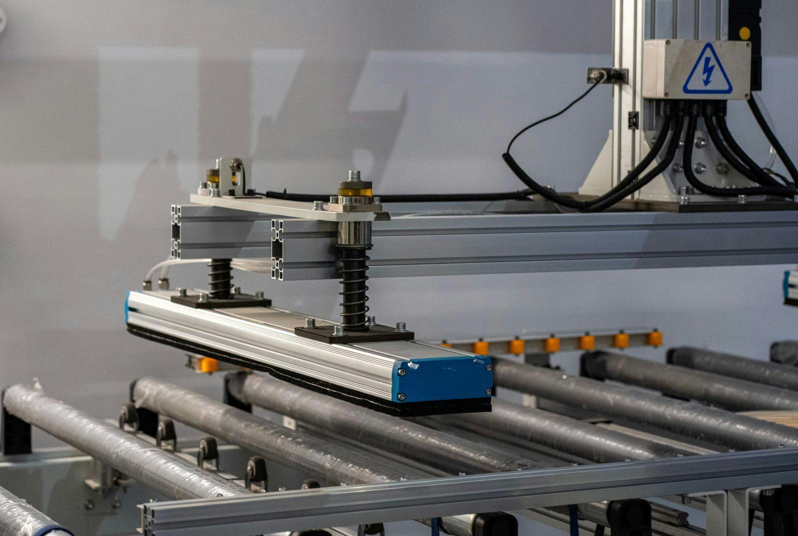 Robotic Machine Frame with Spring Assembly and Conveyor Rollers &ndash; Industrial Automation Detail