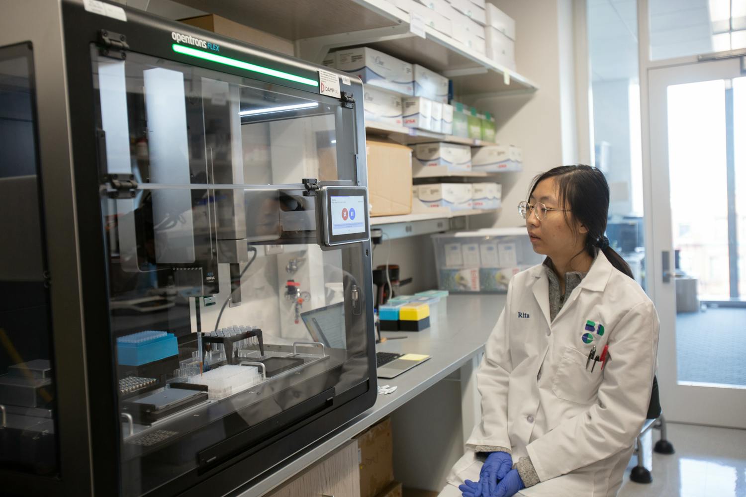 researcher views Opentrons Flex automated lab equipment