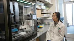 researcher views Opentrons Flex automated lab equipment researcher views Opentrons Flex automated lab equipment