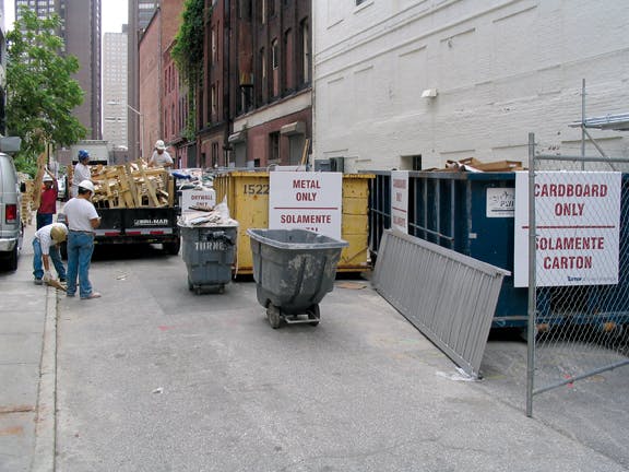Construction Waste Signage In Both English And Spanish At A Job Site Alerts Workers To The Importance Of C&d Waste Diversion