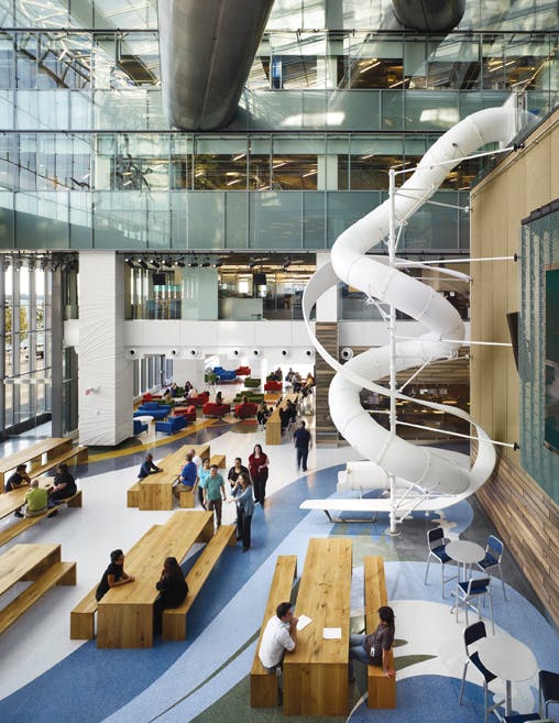 The colorful ribboned flooring at Torontos Corus Quay mimics the iconic corkscrew slide and draws attention to visible pathways