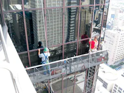 Workers repair a failed glass curtain wall. As glazed curtain walls age, many of their components may reach the end of their se Workers repair a failed glass curtain wall. As glazed curtain walls age, many of their components may reach the end of their se