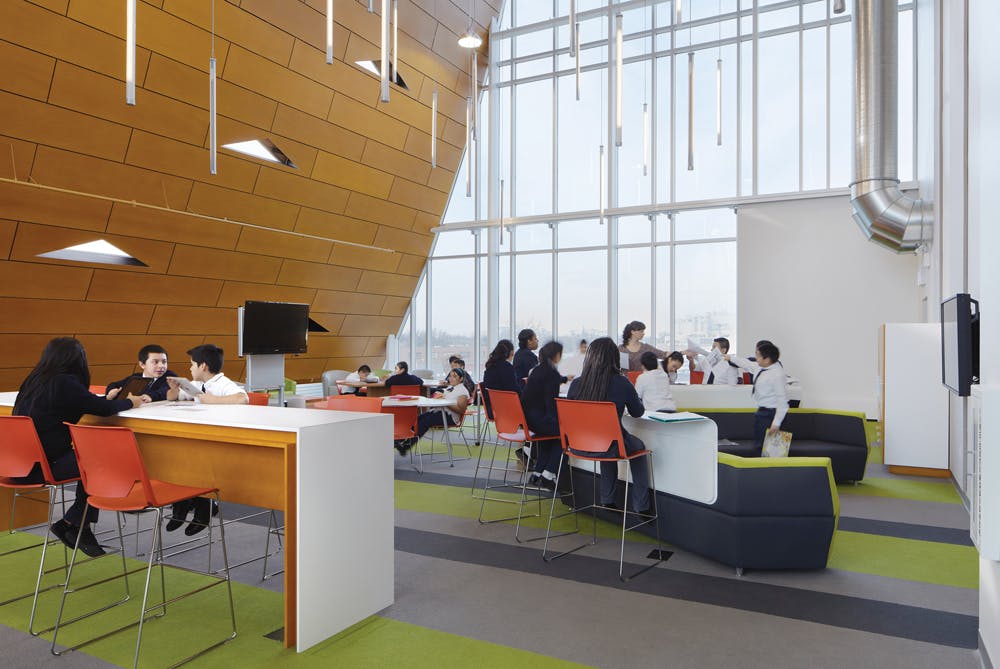 The bookless Digital Library at UNO Galewood Charter School, one of 13 UNO charters serving Chicagos Hispanic community. Students sit at genius bars and use tablets and mobile devices to do their work. UNO wanted to break the mold of what a library is, says Patricia Saldaa Natke, Principal in Charge at UrbanWorks, Ltd., the schools designer. Christopher Barrett Photography