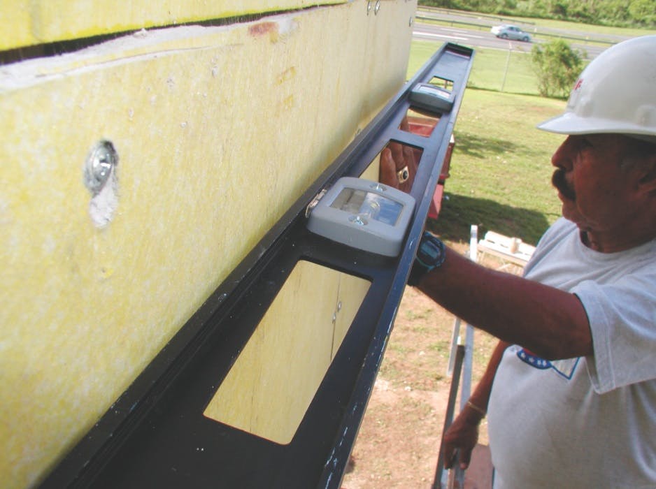 To true the wall surface, the installer should level the insulation board, rather than build up the base coat. Checking stud ali